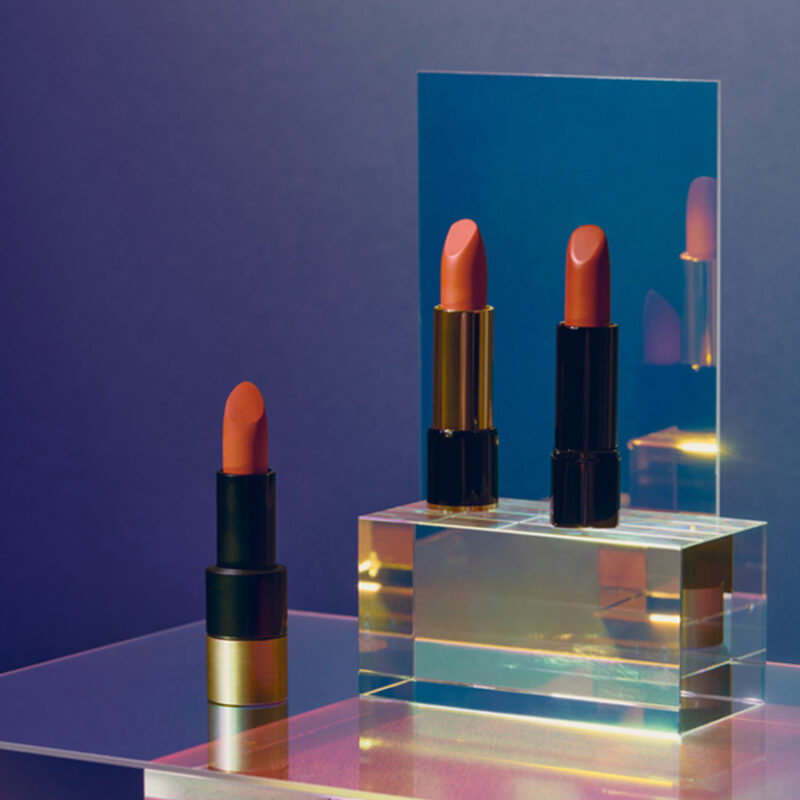 three lipsticks on visual, translucent background