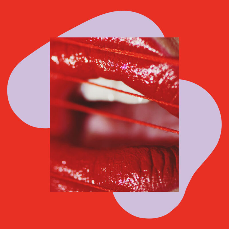 close up of red painted lips with graphic background